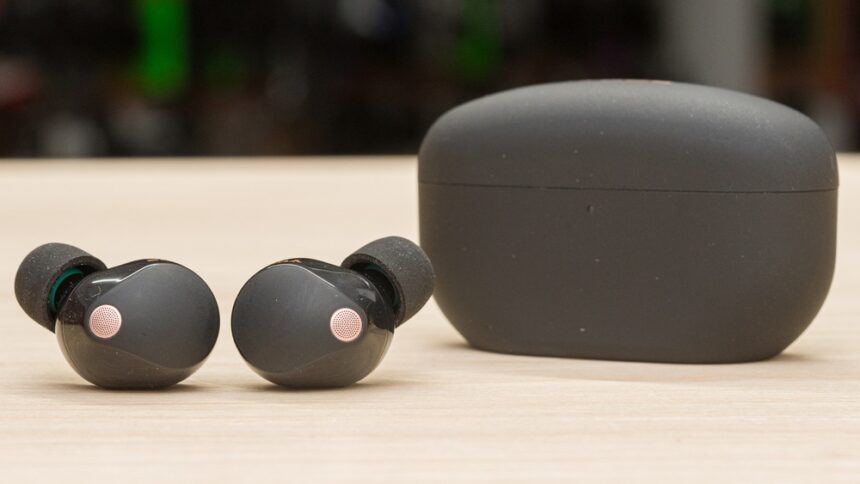 Sony WF-1000XM5 black earbuds with foam ear tips in charging case